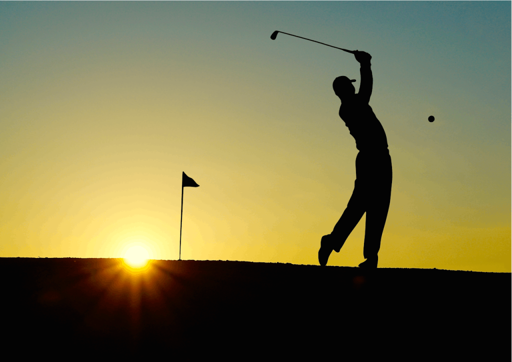 Silhouette of a golfer swinging at sunrise, capturing the essence of the sport.