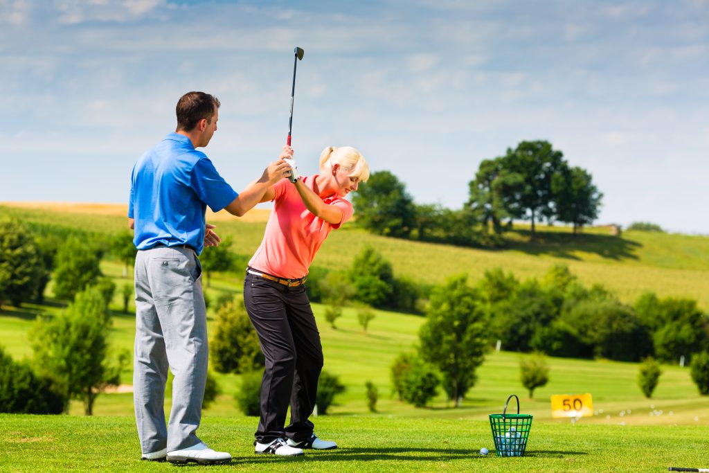 young female golf player on course